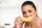 Creative portrait of woman holding yellow banana in her hand.