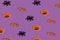 Creative purple pattern made of pumpkin, bat and spiders. Halloween concept. top view, copy space