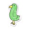 A creative retro distressed sticker of a cartoon parrot