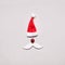 Creative Santa Claus portrait of hat, ball and cut out paper mustache. Christmas New Year flat lay