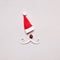 Creative Santa Claus portrait of hat and cut out paper mustache on gray background. Minimal Christmas concept