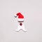 Creative Santa Claus portrait of hat and cut out paper mustache. Minimal Christmas concept