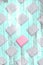 Creative seamless diagonal pattern with one pink gift box among grey ones with turquoise Zine textured overlay.