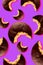 Creative seamless pattern of chocolate bitten sandwich cookies on neon purple background with shadows in pop-art style