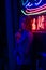 Creative sexual portrait of a girl in neon lighting with glasses, night party, dancing, game business, striptease