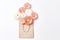 Creative shopping concept, simple flat layout. craft package and Aster flowers on a white background, top view, copy space