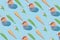 Creative spring pattern made with ice cream cones, pink tulips, coffee cups and green leaves on blue background