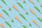 Creative spring pattern made with ice cream cones, pink tulips and green leaves on blue background