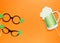 Creative st Patricks Day orange background. Flat lay composition of Irish holiday celebration with photo booth decor