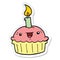 A creative sticker of a cartoon cupcake with candle