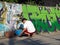 Creative Street Artist Painting Graffiti on Urban Wall. Bali Indonesia.