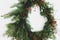 Creative stylish christmas wreath with red berries and fir branches close up