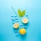 Creative summer composition with sliced lemon, straw and ice cubes on blue background. Minimal drink concept