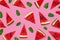 Creative summer food concept. Watermelon pattern. Juicy slices of ripe red watermelon and mint leaves on pink background. Flat lay