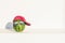 Creative and summer picture of watermelon in the form of a human head in the sunglasses headphones and red cap on the white wall b