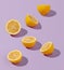Creative sunlit isometric concept with lemon halves on abstract lilac background