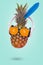 Creative trendy summer invitation card with pineapple wearing sunglasses made of fresh orange and headphones on pastel blue