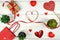 Creative Valentine Day romantic composition with red hearts, satin ribbon, lollipop, gift box, potted succulents and paper bag on