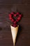 Creative Valentine`s Day romantic concept composition flat lay top view love holiday red heart raspberry waffle cone