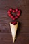 Creative Valentine`s Day romantic concept compositionÑŽ flat lay top view love holiday celebration red heart raspberry waffle cone