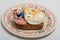 Creative work: a boy lies on a toast bread with an egg and sausage on a plate on a light background