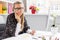 Creative young business woman talking on phone in office