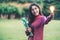 Creative young woman hold shinning light bulb.