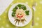 Creatively decorated octopus salad. Children`s menu on a green background.