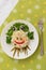 Creatively decorated octopus salad. Children`s menu on a green background