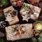 Creatively wrapped Christmas gifts in rustic style on wooden table top view