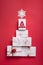 Creatively wrapped and decorated christmas presents in boxes on red background. Top view from above. Flat lay wit copy space ,