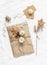 Creativity is a concept. Autumn gift packaging in craft paper with flowers, cones, twigs on a light background, top view