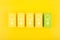 Creativity concept. Light bulbs on yellow and green toy blocks against bright yellow background