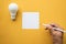 Creativity inspiration,ideas concept with lightbulb and notepad