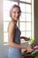 Creativity is a wild mind and a disciplined eye. a beautiful woman completing a floral bouquet on a wooden counter top.