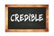 CREDIBLE text written on wooden frame school blackboard