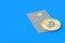 Credit card and coin of bitcoin on blue background