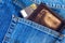 Credit card in wallet in pocket of jeans, closeup. Closeup of wallet and credit card in jeans trousers pocket