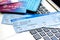 Credit cards with airline tickets for vacations on laptop background