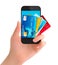 Credit cards in a phone. Internet banking concept.
