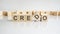 Credo text on a wooden blocks, gray background