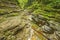 Creek with pure water in the deep dark canyon.