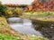 Creek under high bridge in autumn