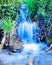 Creek waterfall rushing green meadow grass plants