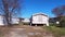 Creekside Trailer park slow pan of a boarded up trailer
