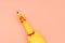 Creeping, rubber chicken toy on a pastel pink background. Rubber toy Chicken that screams isolated on a coral background.