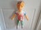 creepy colorful boy or child mannequin or doll hanging on door