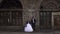 Creepy couple in a wedding dress with makeup for Halloween stand near brick wall