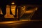 Creepy, dimly lit underpass below an iron bridge