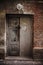 Creepy door in damaged building in slum district